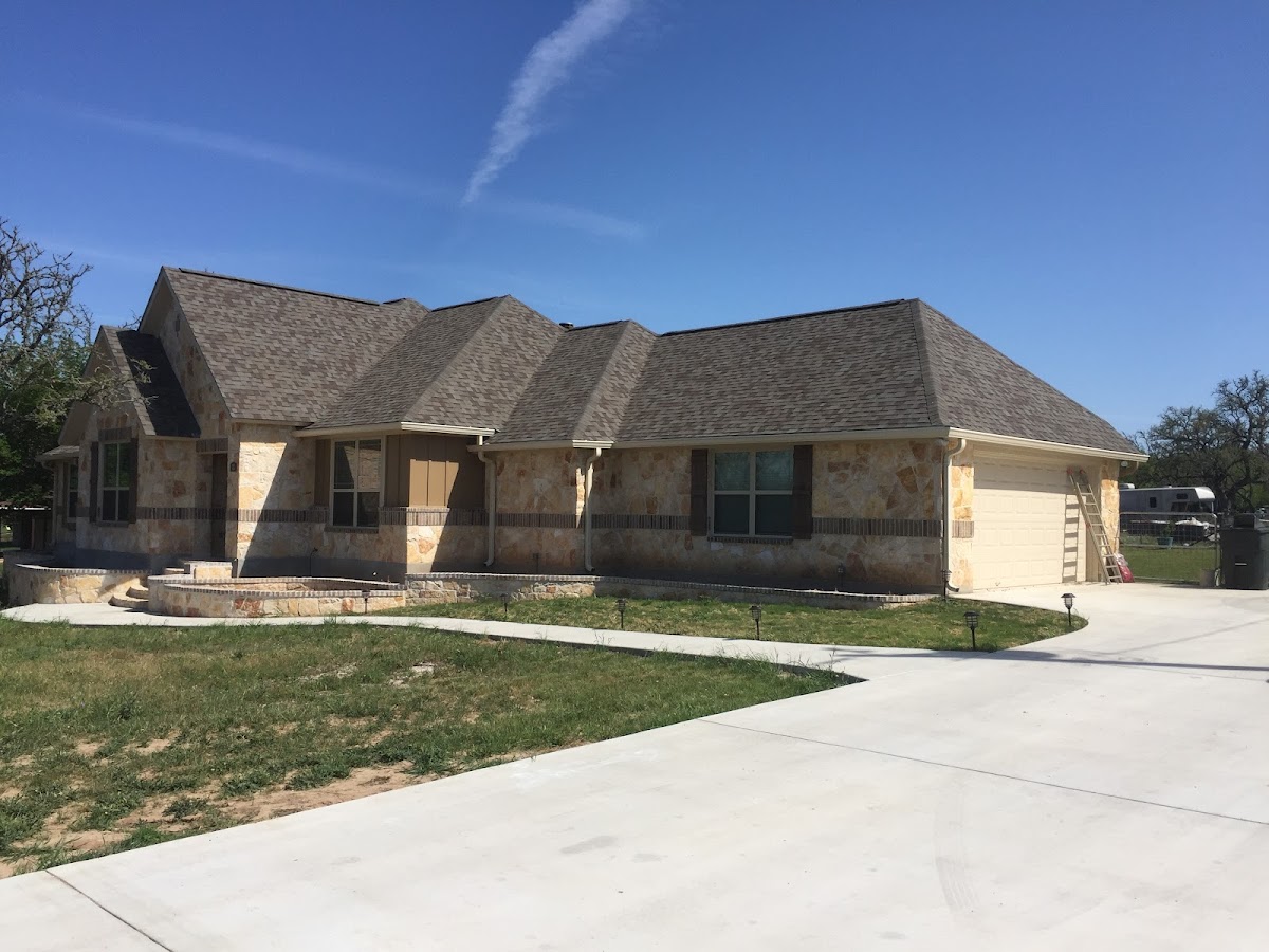 Completed roofing work on a Hill Country stone home