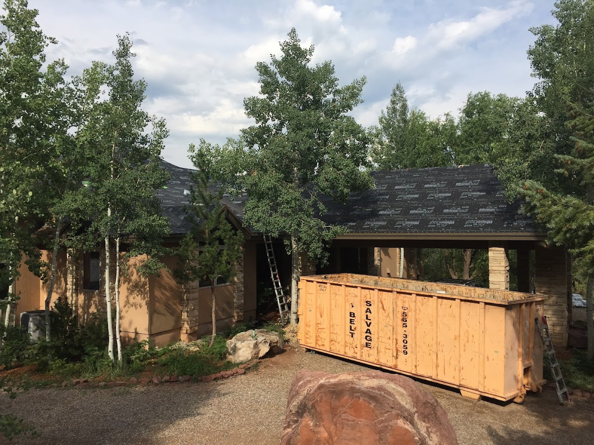 Crew tearing off and replacing a roof mid-job