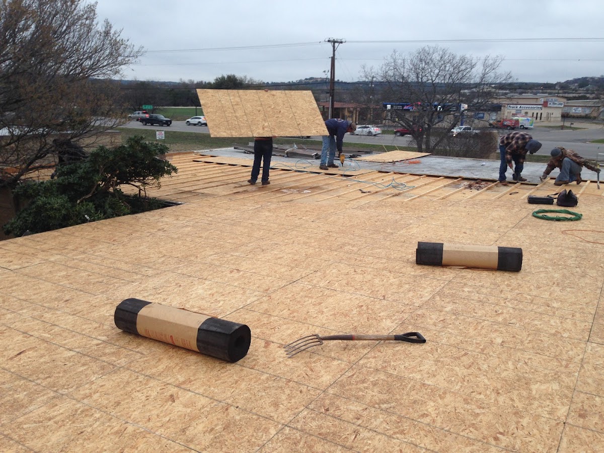 Crew laying flat roof decking